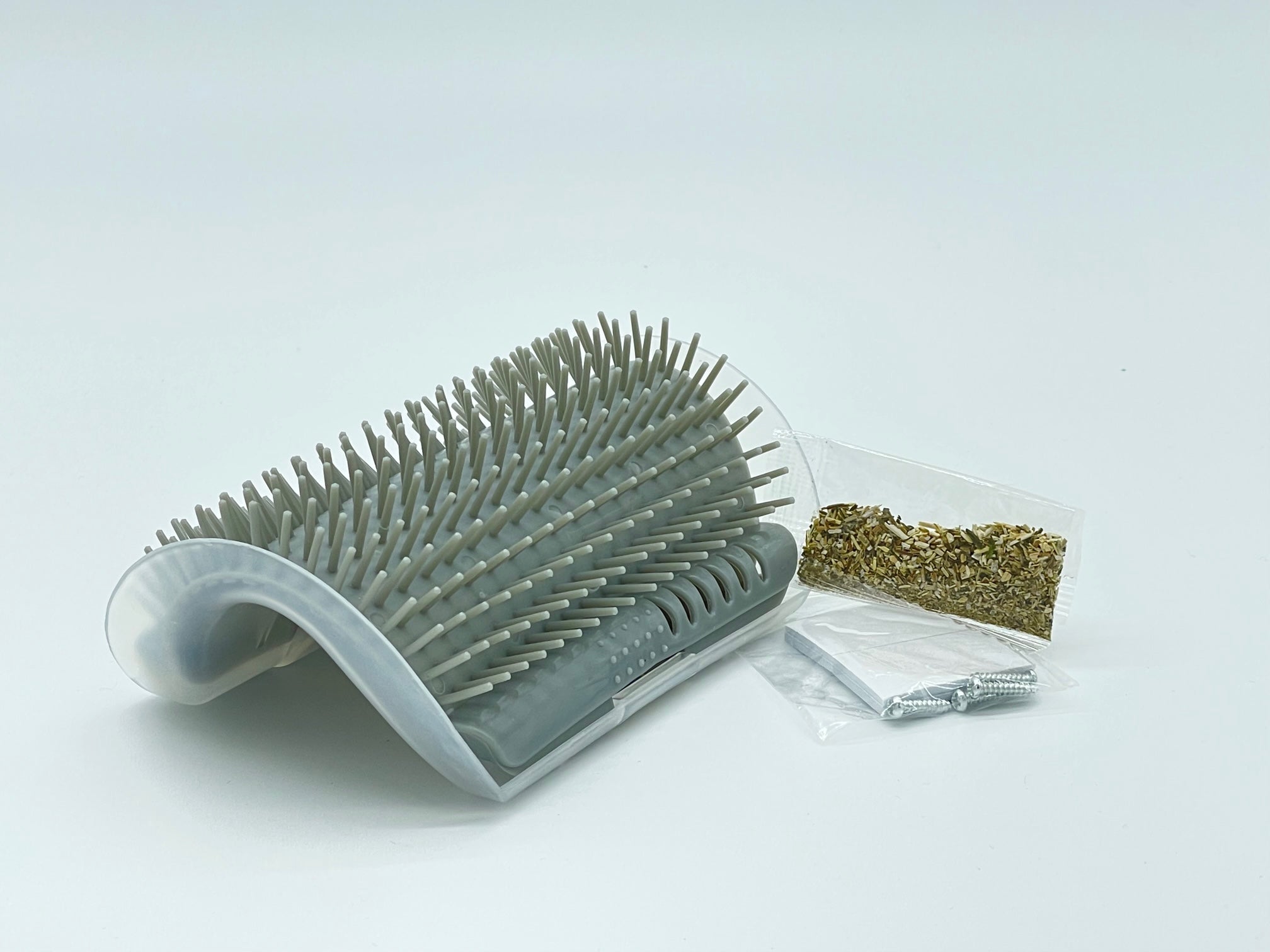 Self-grooming pet corner tool from Toys N Treats Box, with a sleek design and textured surface for grooming cats and small pets.