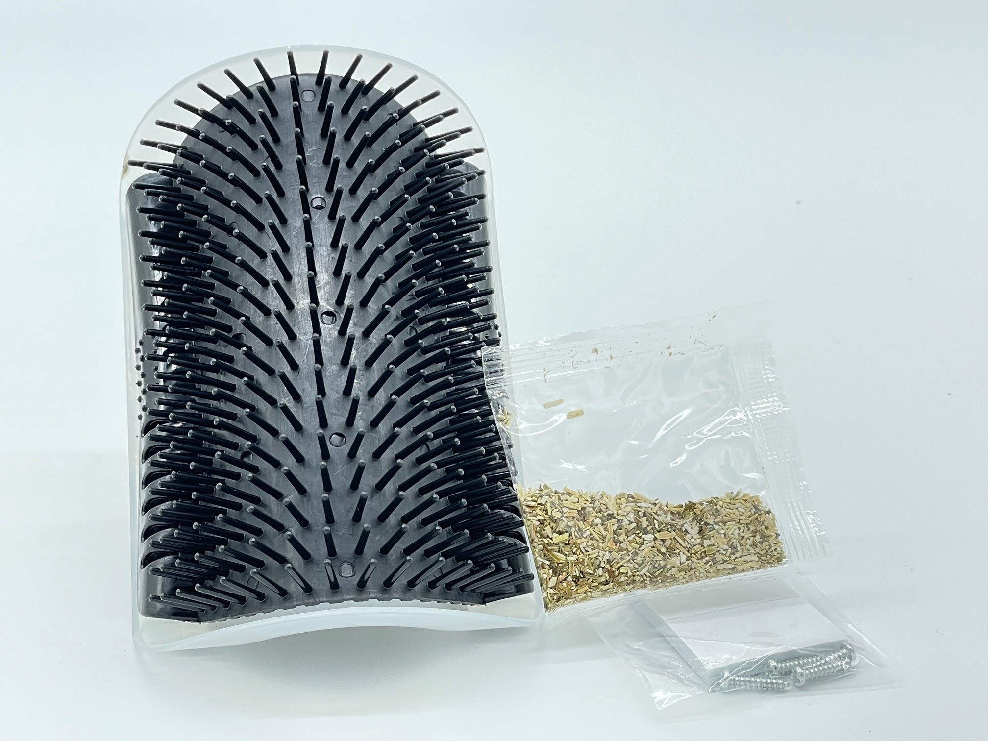 Self-grooming corner tool from Toys N Treats Box, designed for pet grooming, showing a compact grooming accessory with textured surface.