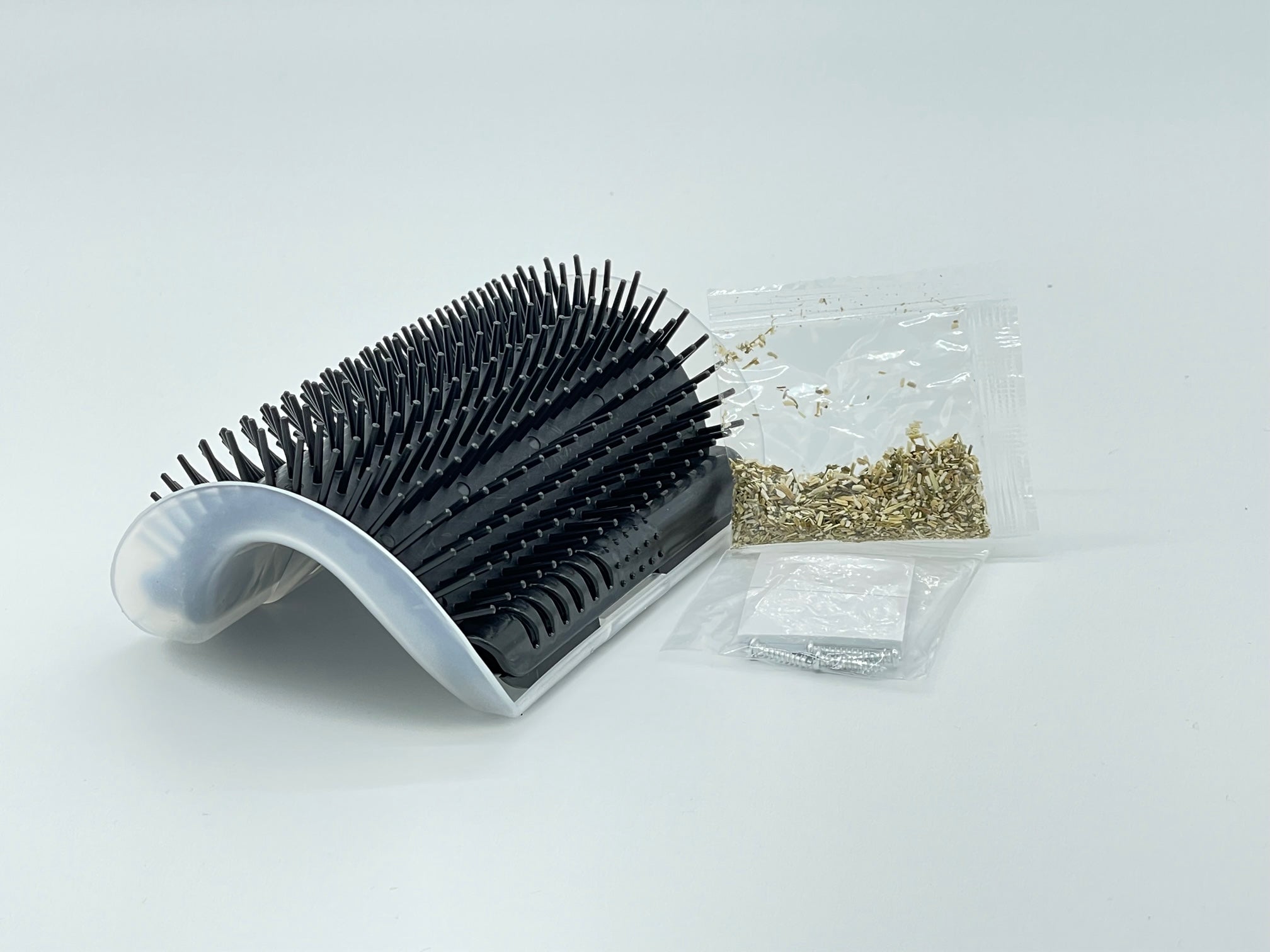 Self-grooming corner tool from Toys N Treats Box for pets, featuring a compact design with bristles for easy grooming.
