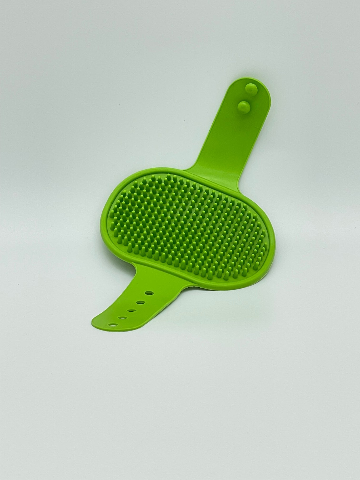 Pet grooming brush from Toys N Treats Box with pet massage and shampoo tool, showing bristles and ergonomic handle.