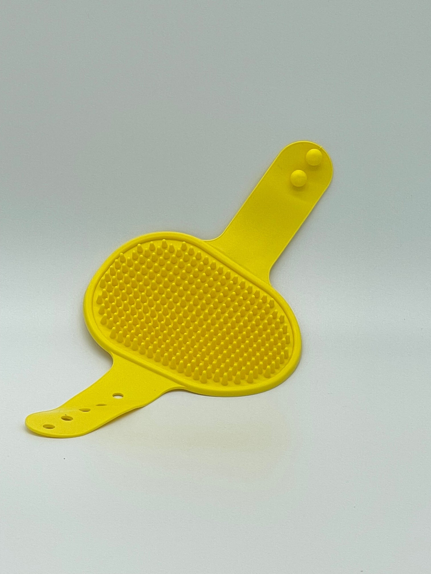 Pet grooming brush by Toys N Treats Box, a pet massage and shampoo tool with bristles for gentle grooming and detangling.