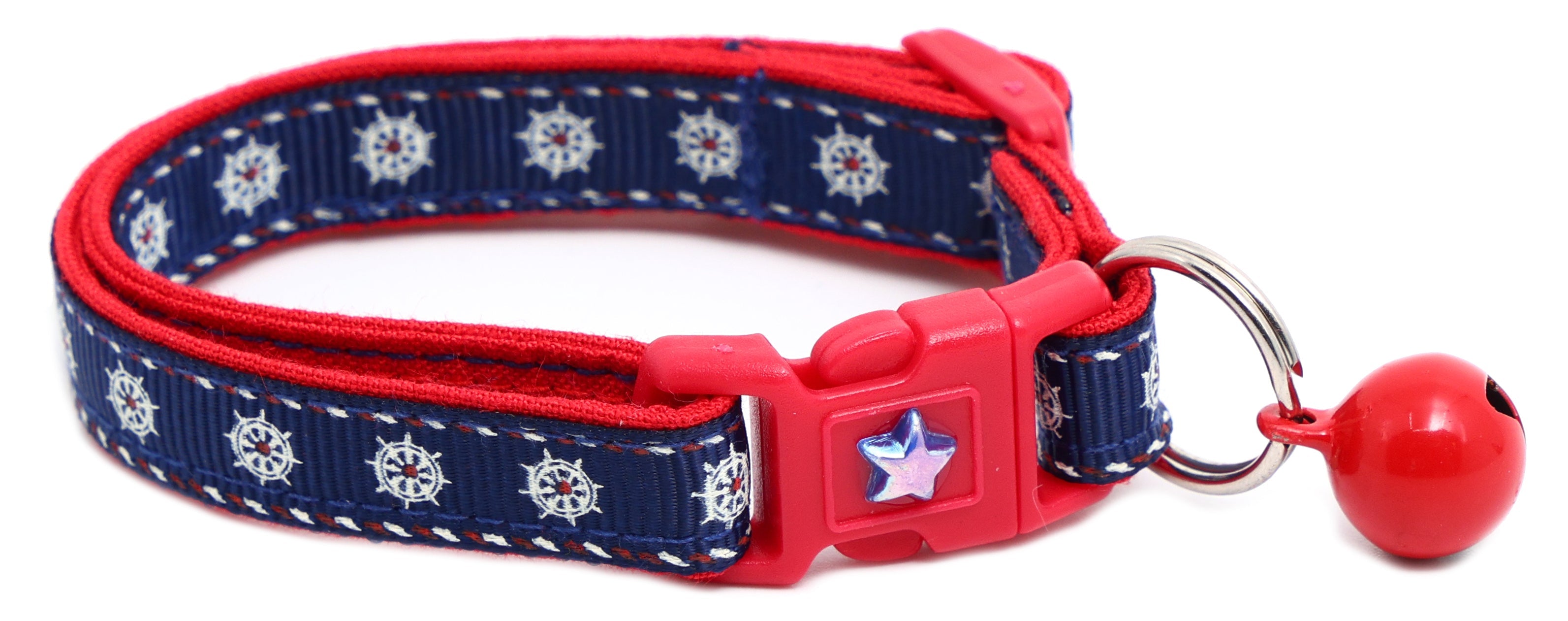 Nautical-themed Ships Wheels Breakaway Cat Collar by Pugs2Persians on a playful kitten, featuring a safe breakaway design and nautical details.