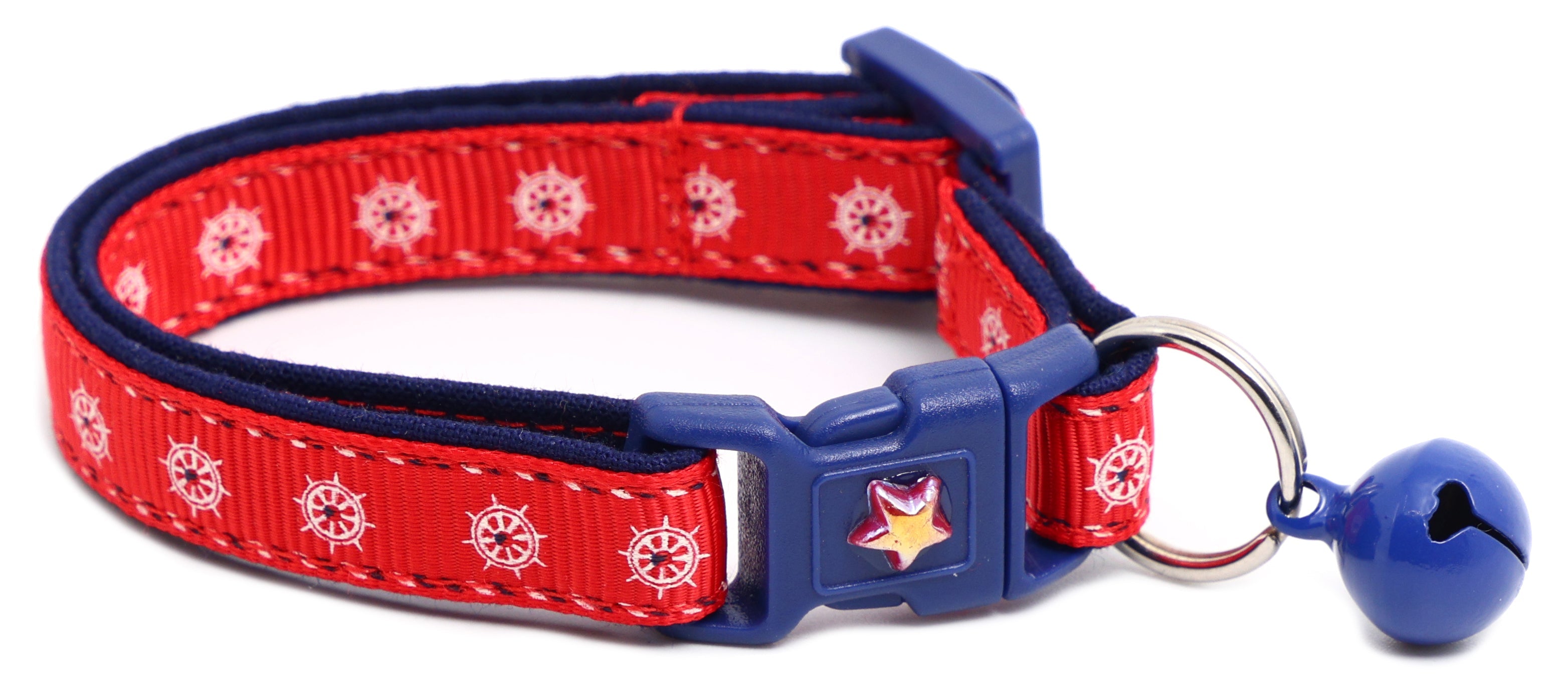 Nautical-themed Ships Wheels Breakaway Cat Collar by Pugs2Persians on a kitten with a blue collar featuring a ship wheel design.