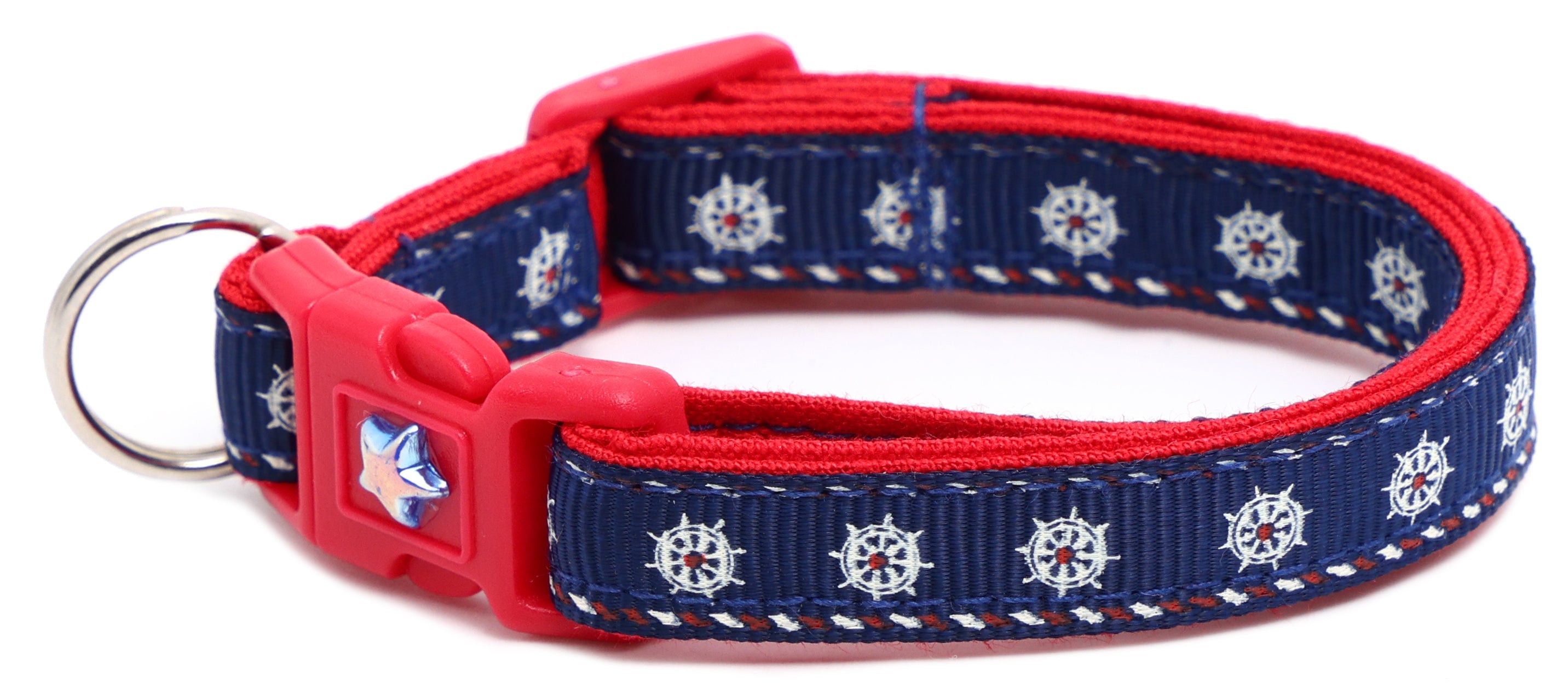 Nautical-themed Pugs2Persians breakaway cat collar with ship wheel design on a curious kitten.