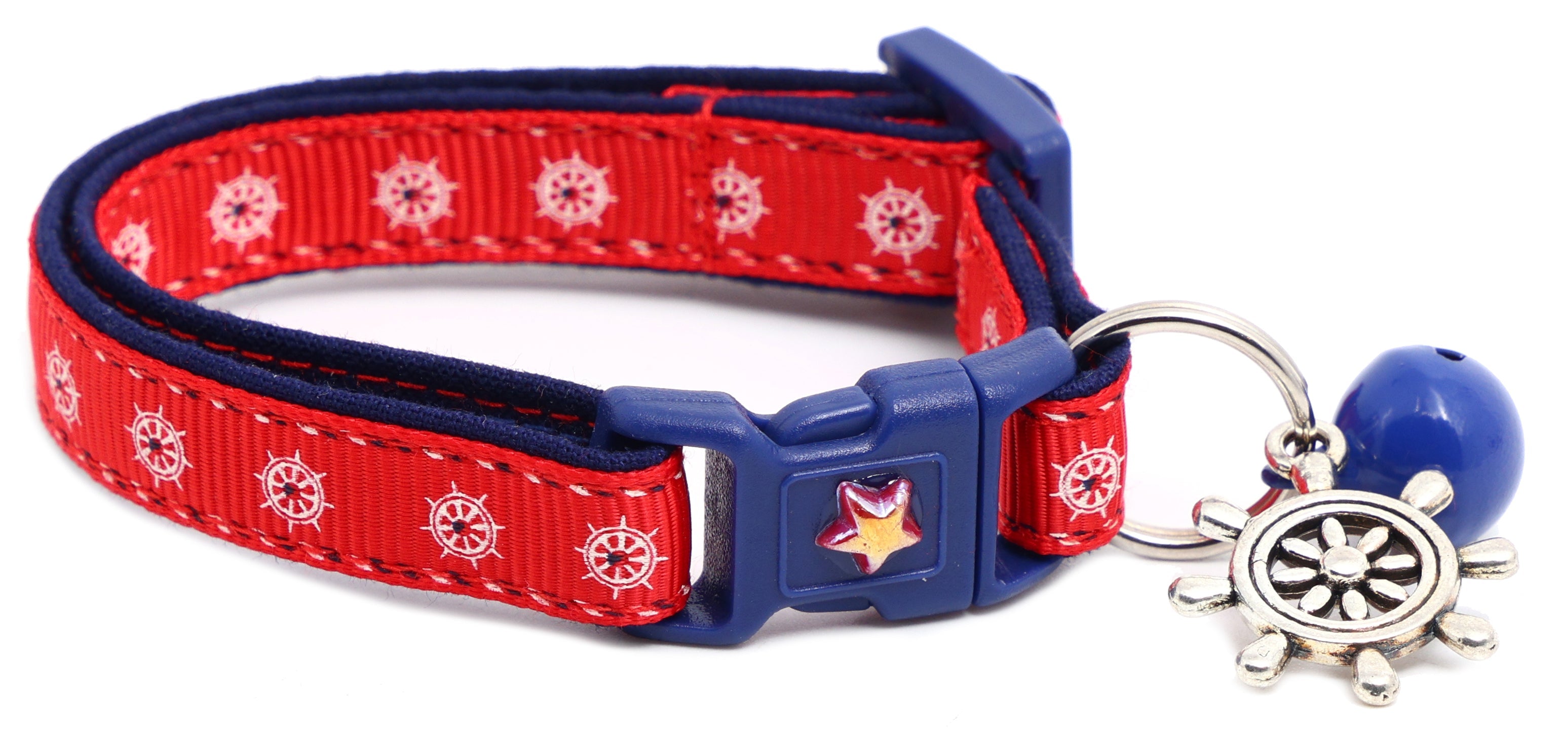 Nautical design Pugs2Persians Ships Wheels breakaway cat collar on a kitten, featuring a maritime-themed ship wheel charm.