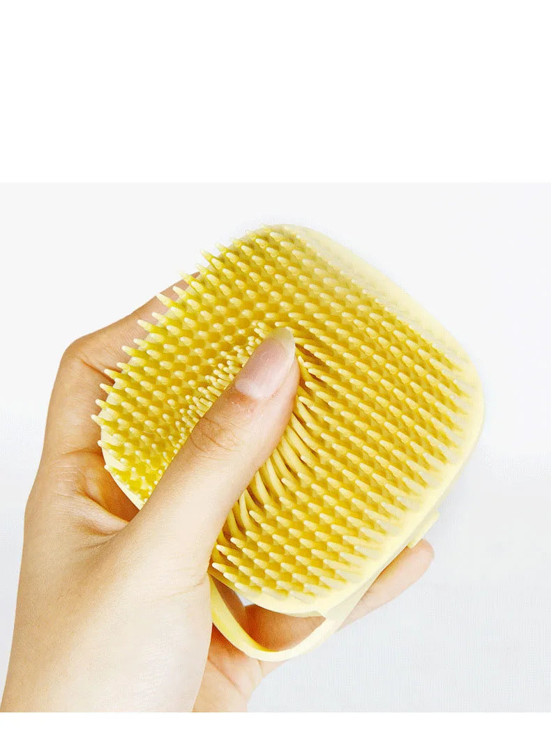 Silicone pet bath brush with massage and shampoo dispenser for dogs and cats, designed for easy grooming and cleaning.